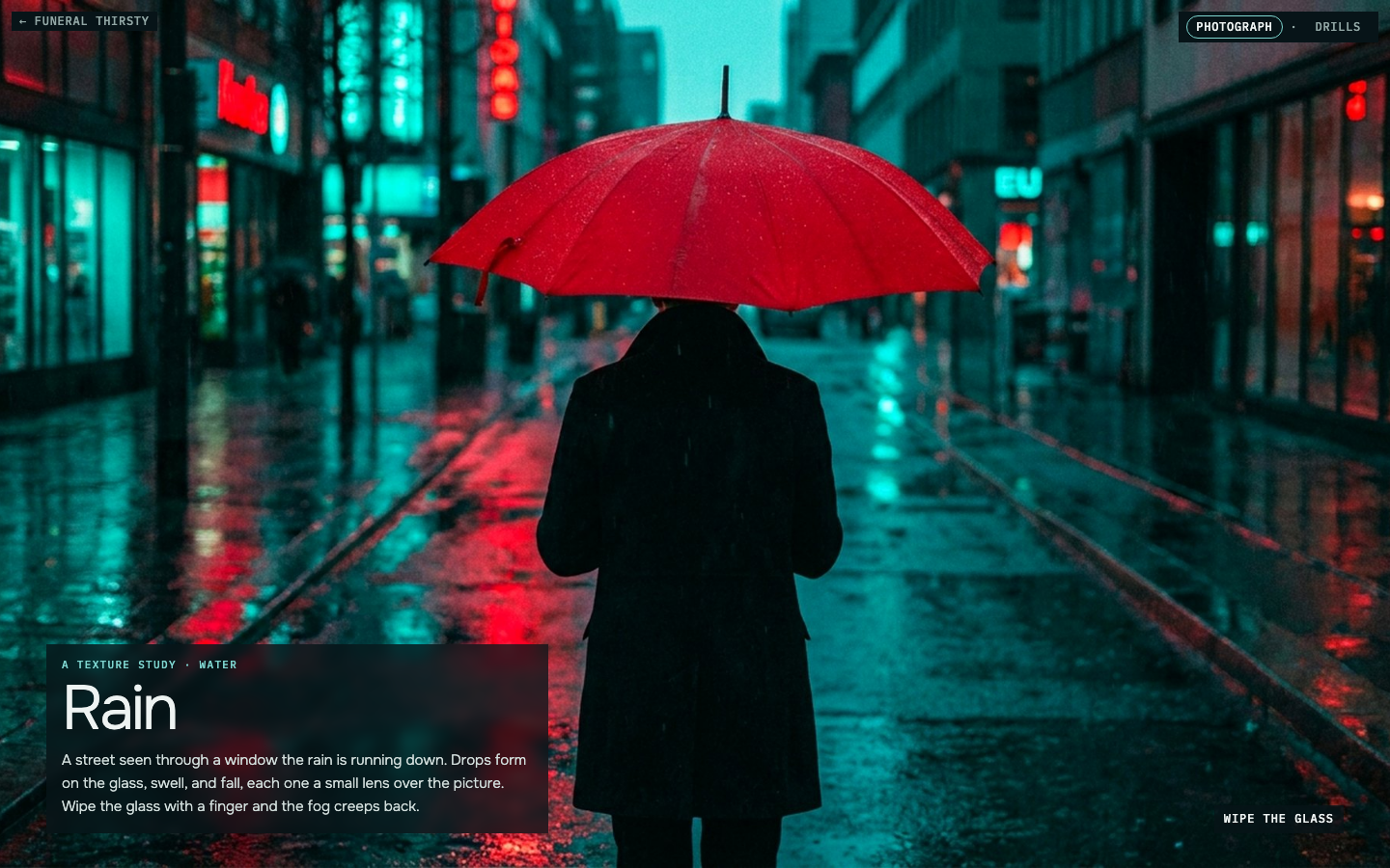 Rain: a figure under a red umbrella on a teal street, seen through glass beaded with raindrops, one runner leaving a clear trail down the fog